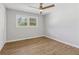 Bright bedroom with ceiling fan, wood floors and a large window with natural light at 6684 Birch Rd, Winston, GA 30187