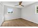 Bedroom features natural light, wood-look floors and a ceiling fan at 6684 Birch Rd, Winston, GA 30187