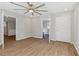 A large, light-filled bedroom featuring wood floors, a ceiling fan, and neutral paint at 6684 Birch Rd, Winston, GA 30187
