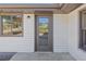 Home exterior featuring a glass paneled front door and sidelight window at 6684 Birch Rd, Winston, GA 30187