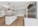 Kitchen with island, wood countertop, stylish lighting, and gray backsplash at 6684 Birch Rd, Winston, GA 30187