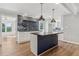 Modern kitchen with island, pendant lighting, and backsplash with open shelving at 6684 Birch Rd, Winston, GA 30187
