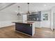 Modern kitchen with a central island, stylish lighting, and sleek herringbone backsplash at 6684 Birch Rd, Winston, GA 30187