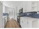 Kitchen with stainless steel appliances, white cabinetry, and sleek countertops at 6684 Birch Rd, Winston, GA 30187
