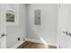 The laundry room has new flooring and neutral walls with a bright window at 6684 Birch Rd, Winston, GA 30187