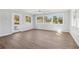 Spacious living room with luxury vinyl plank floors, ceiling fan and multiple windows at 6684 Birch Rd, Winston, GA 30187
