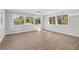 Spacious living room with luxury vinyl plank floors, ceiling fan and multiple windows at 6684 Birch Rd, Winston, GA 30187