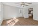 Bright living room with ceiling fan, wood floors and view into the kitchen at 6684 Birch Rd, Winston, GA 30187