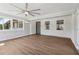 Spacious living room with luxury vinyl plank floors, ceiling fan and multiple windows at 6684 Birch Rd, Winston, GA 30187