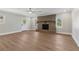 Comfortable living room featuring hardwood floors, fireplace, and a modern ceiling fan at 6684 Birch Rd, Winston, GA 30187