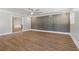 Stylish living room with hardwood floors, modern wall paneling, and neutral color palette at 6684 Birch Rd, Winston, GA 30187