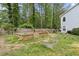 Backyard showcasing multiple raised garden beds, a wooden fence, and a seating area at 100 Karla Ct, Roswell, GA 30076