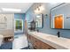Bright bathroom featuring double vanity, tile floors, and a stylish glass-enclosed shower at 100 Karla Ct, Roswell, GA 30076