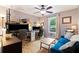 Bedroom with multiple desks, a ceiling fan, and a comfortable blue sofa at 100 Karla Ct, Roswell, GA 30076