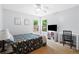 Well-lit bedroom features neutral walls, a comfortable bed, a desk, and large windows overlooking the outdoors at 100 Karla Ct, Roswell, GA 30076
