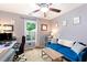 Cozy bedroom with a comfortable blue sofa, desk, and bright window view at 100 Karla Ct, Roswell, GA 30076