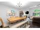 Bright dining room features a large table, a bench, hardwood floors and a ceiling fan at 100 Karla Ct, Roswell, GA 30076