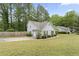 Charming home showcasing a well-maintained lawn, mature trees, and classic architecture at 100 Karla Ct, Roswell, GA 30076