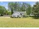 Charming two-story home with manicured lawn, mature trees, and inviting curb appeal at 100 Karla Ct, Roswell, GA 30076