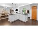 Open kitchen with stone countertops that connects to the dining and living room, features hardwood floors at 100 Karla Ct, Roswell, GA 30076