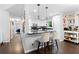 Modern kitchen boasts stainless steel appliances, granite countertops, and stylish breakfast bar seating at 100 Karla Ct, Roswell, GA 30076