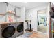 Laundry room featuring a modern washer and dryer, light gray cabinets, and butcher block countertop at 100 Karla Ct, Roswell, GA 30076