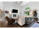 Inviting living room features a fireplace, hardwood floors, neutral decor, and ceiling fan at 100 Karla Ct, Roswell, GA 30076