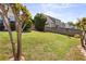 Spacious backyard with lush lawn, mature trees, and a wooden fence at 327 Stone Valley Xing, Canton, GA 30114