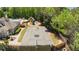 Aerial view of the community basketball court surrounded by trees, fencing and a playground at 327 Stone Valley Xing, Canton, GA 30114