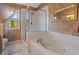 The bathroom features a jetted tub, glass shower and an accent wall with natural light at 327 Stone Valley Xing, Canton, GA 30114
