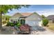 Charming one-story home with stone accents, landscaped yard, and an attached two-car garage at 327 Stone Valley Xing, Canton, GA 30114