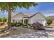 Charming single-story home with well-manicured landscaping, bench, and a two-car garage at 327 Stone Valley Xing, Canton, GA 30114