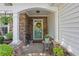 Inviting covered front porch with stone accents, plants, and a charming wreath on the front door at 327 Stone Valley Xing, Canton, GA 30114