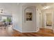 The hallway has wood flooring and an arched alcove that has decorative artwork on the wall at 327 Stone Valley Xing, Canton, GA 30114