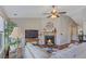 Comfortable living room with wood floors, fireplace, and a large television at 327 Stone Valley Xing, Canton, GA 30114