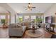 Bright and airy living room with wood floors, a comfortable sectional sofa, and lots of windows at 327 Stone Valley Xing, Canton, GA 30114