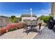 Charming patio area with outdoor seating, flowers, and a well-maintained fence at 327 Stone Valley Xing, Canton, GA 30114