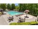 Community swimming pool with plenty of seating and lounging areas surrounded by mature trees at 327 Stone Valley Xing, Canton, GA 30114