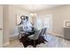 Elegant dining room with a glass-top table, stylish seating, and natural light from the patio doors at 3806 Jack Vernon Cir, Powder Springs, GA 30127