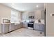 Modern kitchen with sleek gray cabinets, stainless steel appliances, and ample counter space at 3806 Jack Vernon Cir, Powder Springs, GA 30127