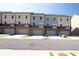 Townhome exteriors each feature basement garages, upper-level balconies, and neutral color schemes under a clear sky at 3806 Jack Vernon Cir, Powder Springs, GA 30127