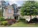 Charming two-story brick home featuring manicured landscaping, a covered entryway, and an attached garage at 808 Wade Farm Dr, Austell, GA 30168