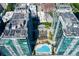 An aerial perspective showcases a condo's outdoor space featuring a blue pool, lounge chairs, and lush landscaping at 923 Peachtree Ne St # 1625, Atlanta, GA 30309