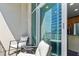 Balcony with seating overlooking city views, and sliding glass doors into the condo at 923 Peachtree Ne St # 1625, Atlanta, GA 30309