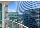 Condo balcony offers stunning city views with modern glass and steel buildings under a bright blue sky at 923 Peachtree Ne St # 1625, Atlanta, GA 30309