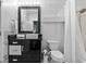 Modern bathroom with black vanity, white fixtures, and decorative wall covering at 923 Peachtree Ne St # 1625, Atlanta, GA 30309