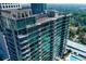 Exterior view of high-rise condo featuring private balconies overlooking lush green landscape and a pool at 923 Peachtree Ne St # 1625, Atlanta, GA 30309