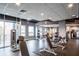 Modern gym featuring various workout machines, free weights, and large windows offering city views at 923 Peachtree Ne St # 1625, Atlanta, GA 30309