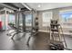 Well-equipped gym with weight machines, free weights, and large windows showcasing city views at 923 Peachtree Ne St # 1625, Atlanta, GA 30309