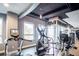 Gym features cardio equipment like treadmills and ellipticals, with weight machines and large windows at 923 Peachtree Ne St # 1625, Atlanta, GA 30309